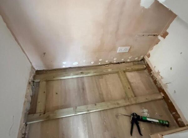 Timber base frame prepared in an alcove for a bespoke fitted wine cabinet installation.