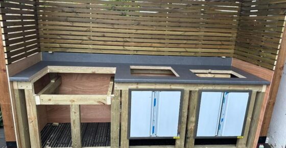 Outdoor cooking station with fitted countertop, storage bays, and appliance openings ready for installation.