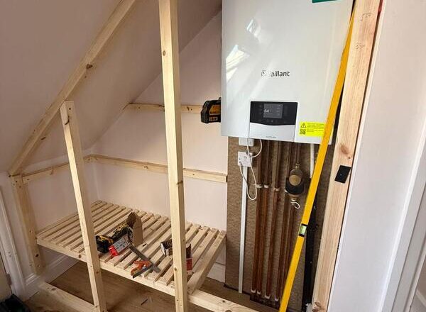 Timber framework built under loft eaves to form a boiler cabinet and storage area in Chingford.