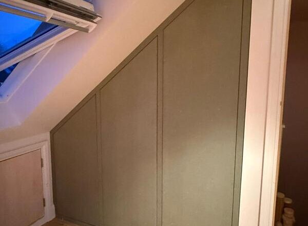 Finished under-eaves cabinet front panels fitted to conceal loft boiler in Chingford.