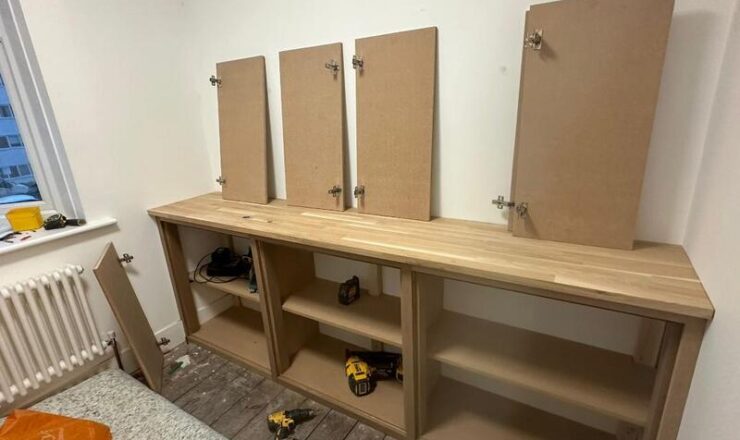 Built-in base cabinet with solid wood worktop and doors prepared for installation in Wanstead.