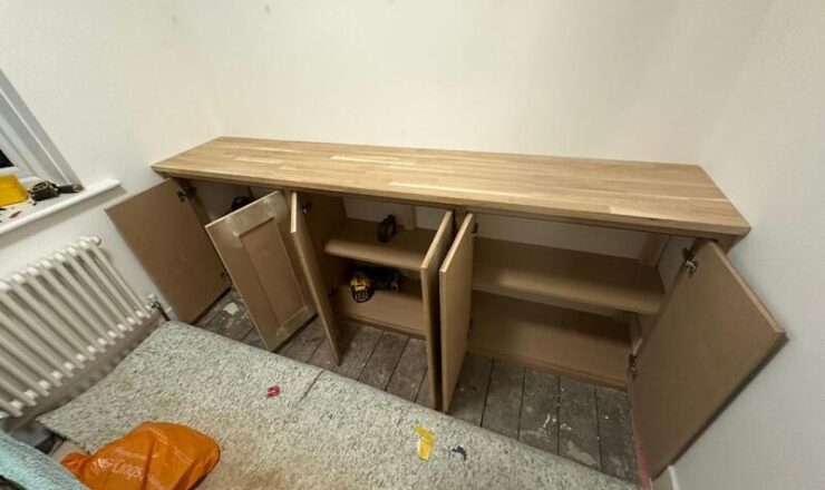 Built-in cabinet doors open showing internal shelves and storage compartments.