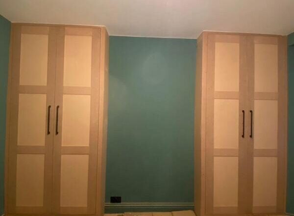 Pair of matching fitted wardrobes installed either side of wall in Loughton with modern shaker finish.