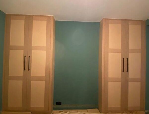 Pair of matching fitted wardrobes installed either side of wall in Loughton with modern shaker finish.