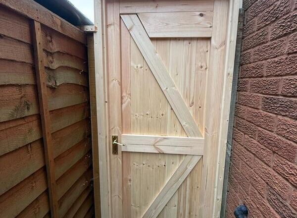Newly installed timber side gate in Chingford before painting, fitted in narrow side passage.