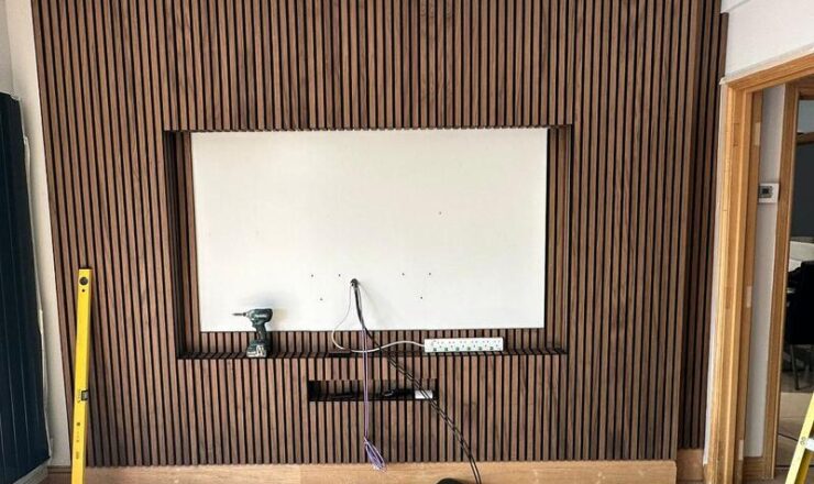 Completed slatted feature wall with central TV recess and concealed cable routing