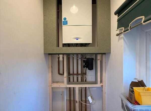 Timber stud framework and moisture-resistant board installed to form boiler enclosure.